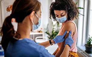 woman getting adhesive bandage after vaccine