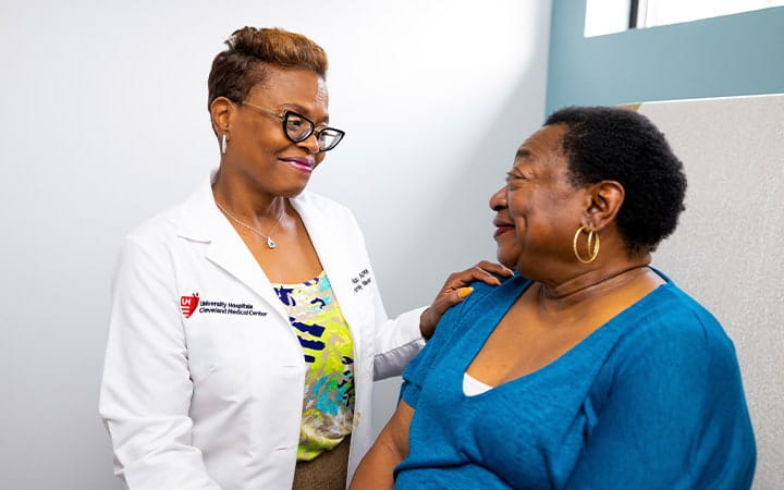 Female doctor talking to adult female patient