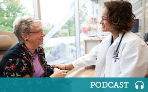 Debora Bruno, MD smiles with a cancer infusion patient