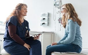 Young woman talking with doctor
