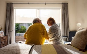 Senior couple sitting on bed
